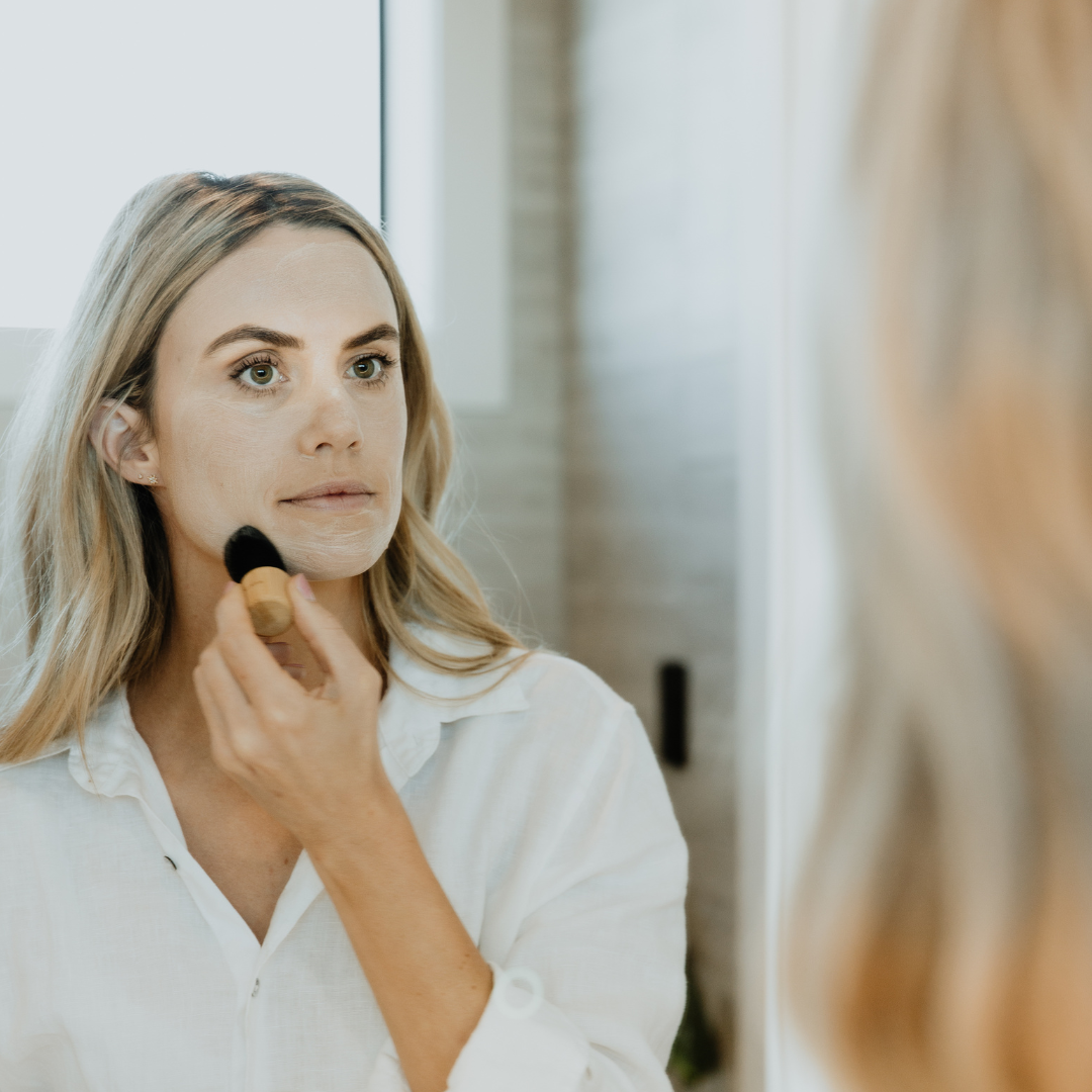 Mirror image of female applying Adashiko Collagen Cleanse to her face | Adashiko Collagen | 100% Natural Skincare